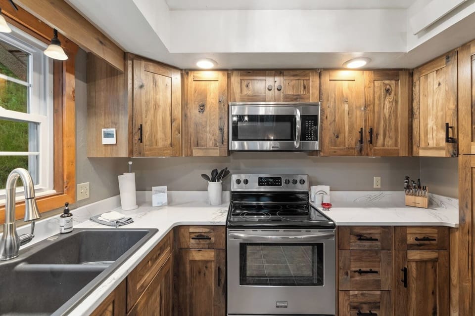 The functional kitchen is well-equipped with everything needed to prepare meals, offering a convenient and inviting space for cooking and gathering.