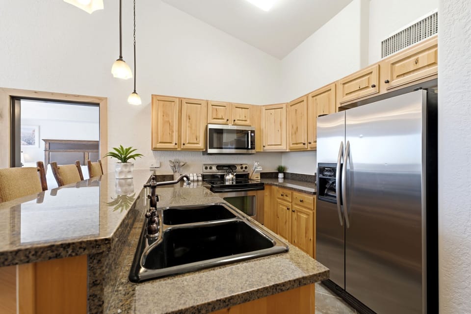 Spacious kitchen with granite countertops and breakfast bar.