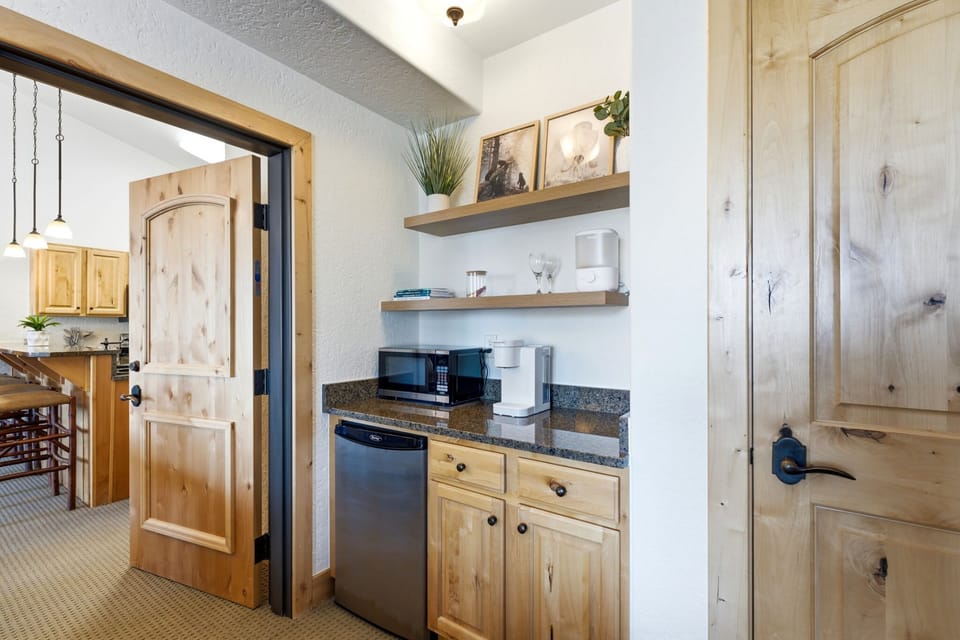 Kitchenette with a coffee maker and mini fridge.
