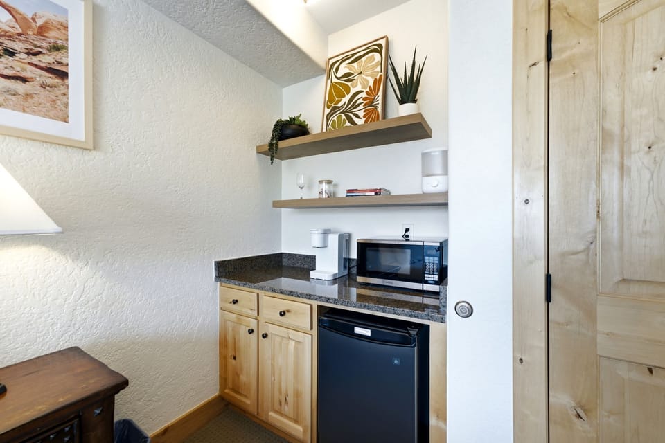 Convenient kitchenette with a coffee maker and mini fridge