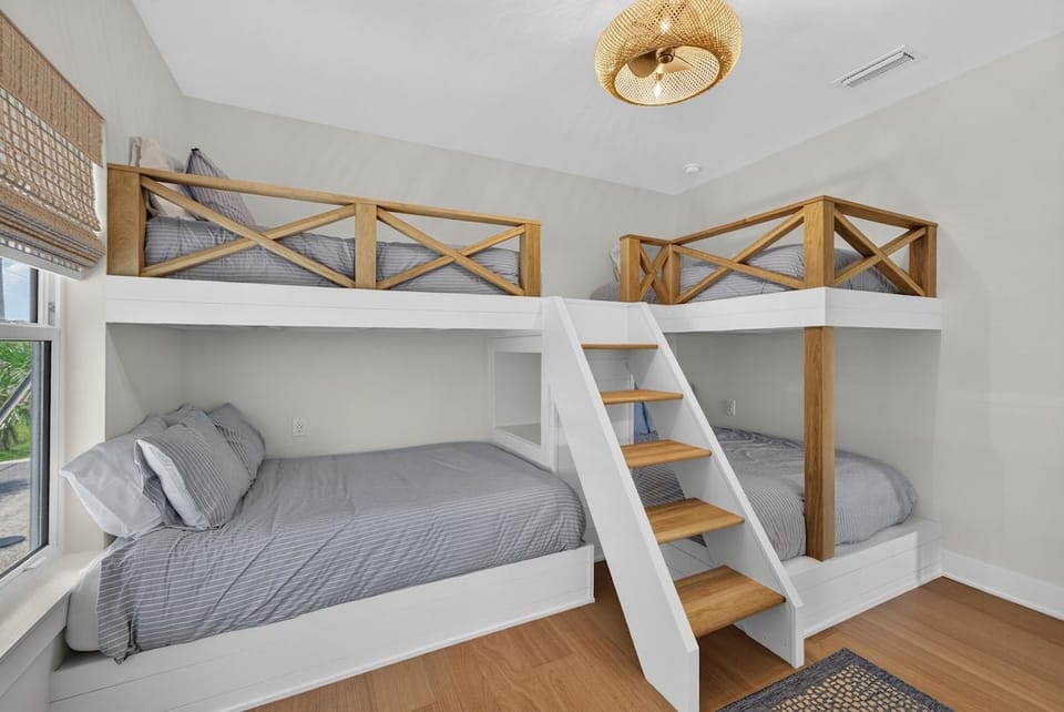 These custom-built bunk beds are in easy reach with natural wood guardrails and an angled ladder.