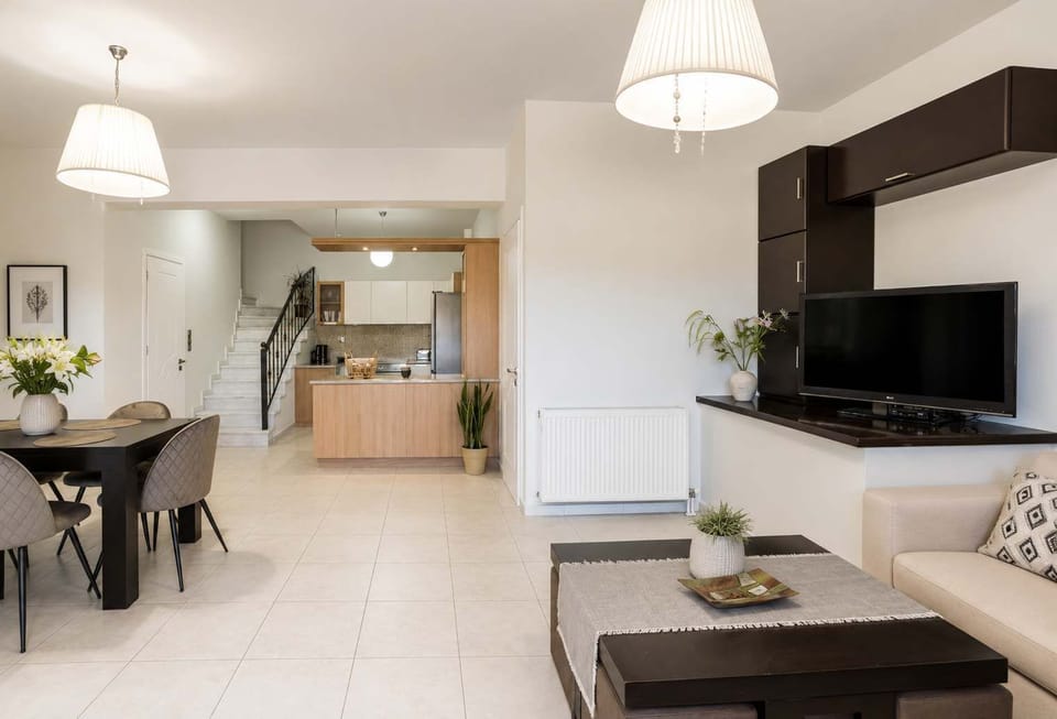 Open living and dining space with a practical layout that keeps the kitchen, table, and seating area connected.