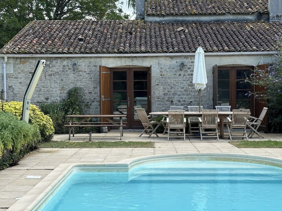 The patio leads straight from the kitchen to access the outdoor seating / dining & BBQ area and the pool