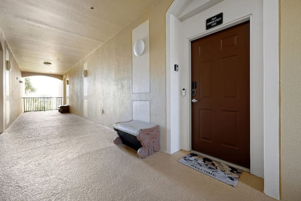 Front door entrance with bench for daily trash pickup