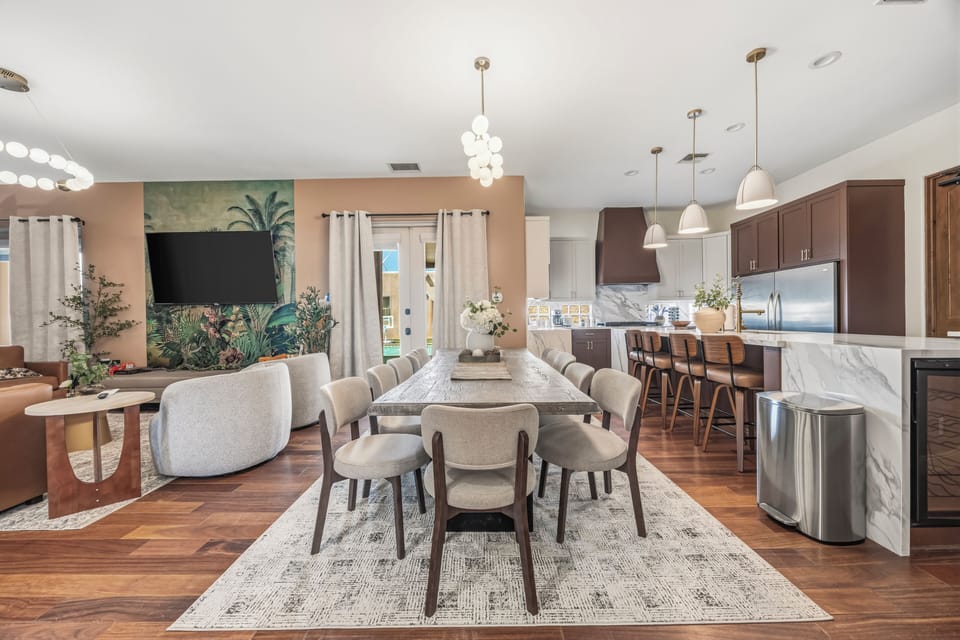 Stylish open kitchen & dining—seats 14, marble counters, pool access.