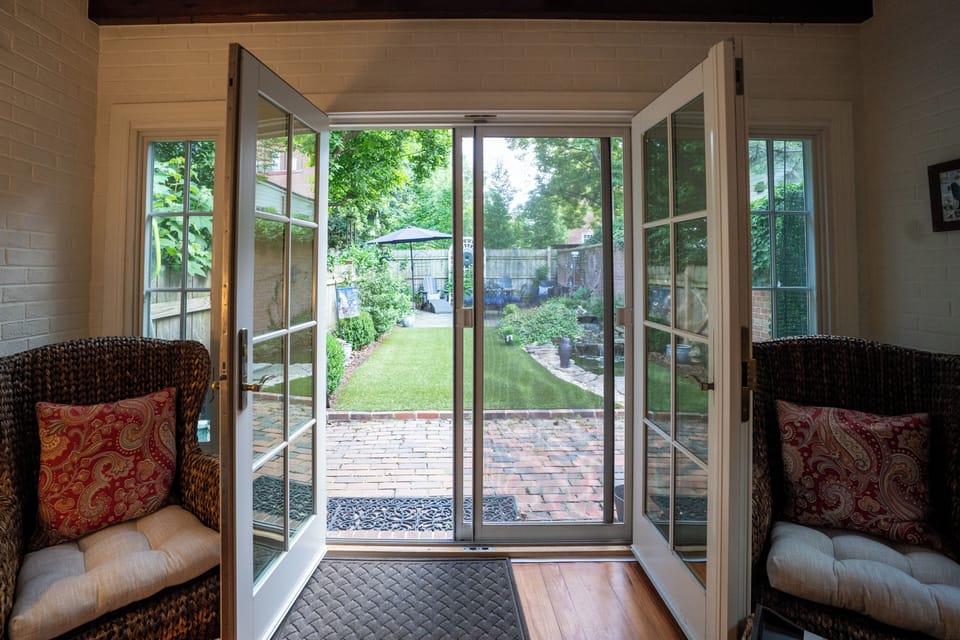 French doors open directly onto the brick patio and backyard