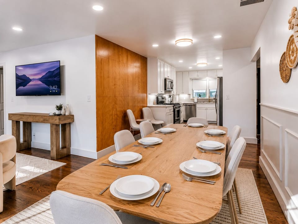 Bright dining for 8 with sleek kitchen and warm modern style