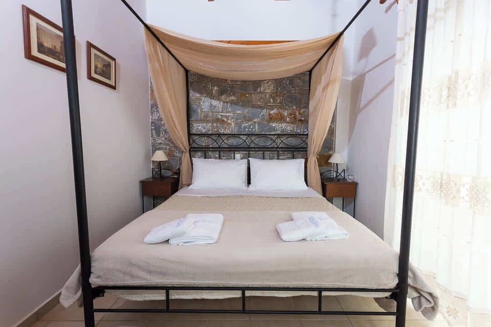 Romantic bedroom with a charming canopy bed and fresh linens.