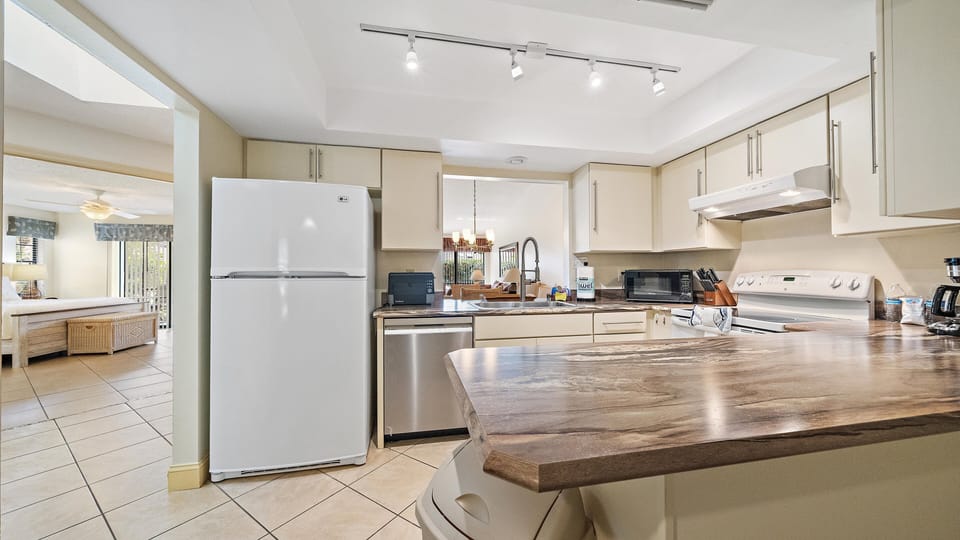 Your spacious, well-equipped kitchen features modern appliances and ample counter space, perfect for preparing home-cooked meals during your stay.