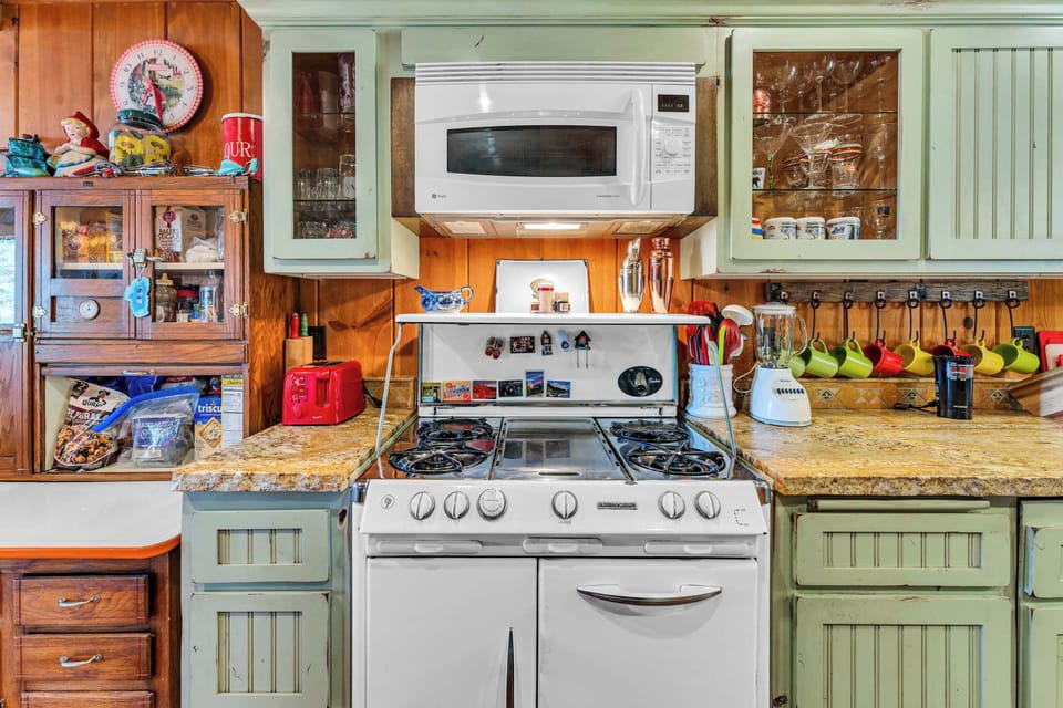 Kitchen: Drip coffee maker, blender, kettle, cooking utensils, tableware, and dedicated workspace
