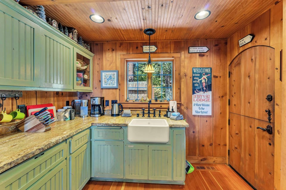 Kitchen: Drip coffee maker, blender, kettle, cooking utensils, tableware, and dedicated workspace
