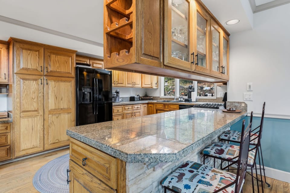 Fully stocked kitchen with island seating for 3 located on the main floor.