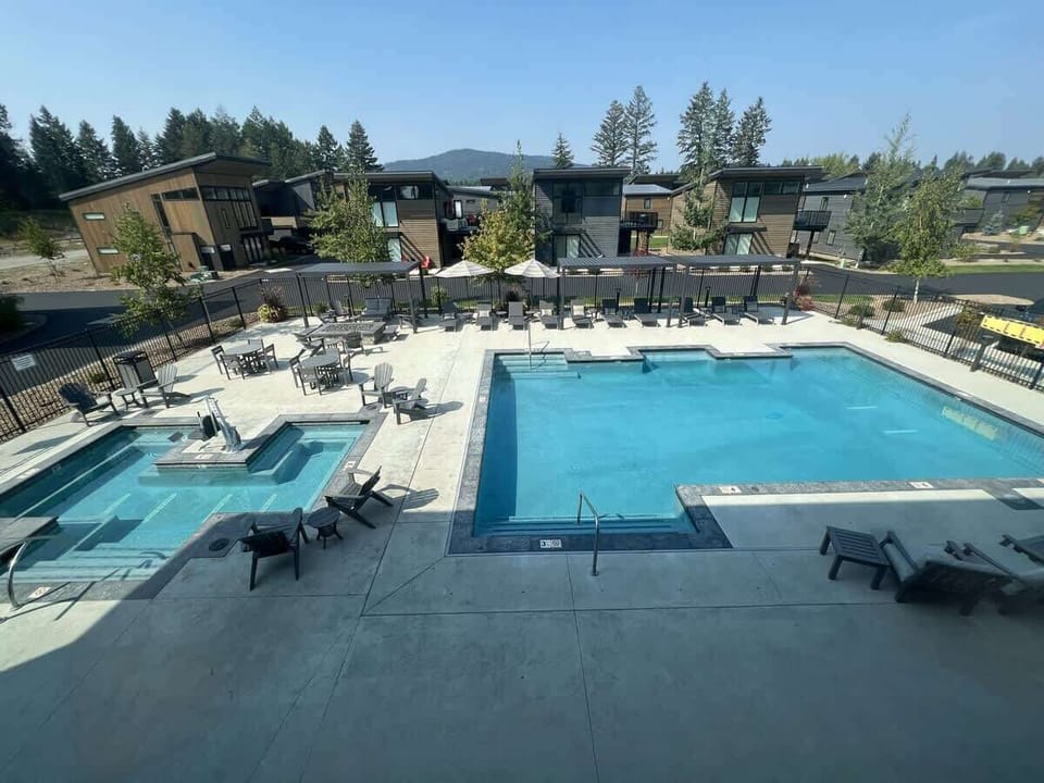 Community clubhouse shared pool (seasonal June - August), hot tub, lounge chairs, shade pergolas, tables & chairs 