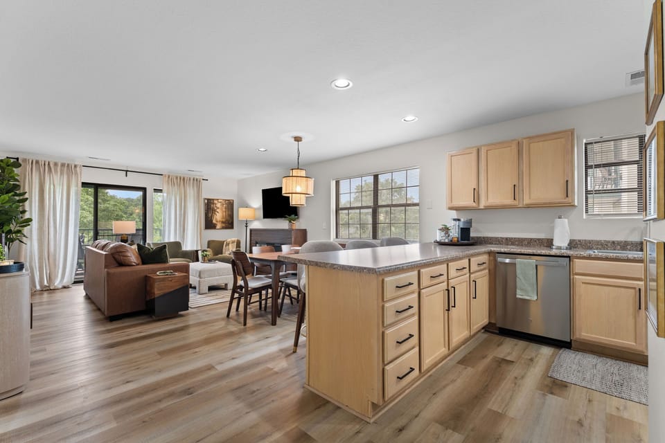 The full kitchen is open to the dining and living areas and stocked for preparing meals at home.