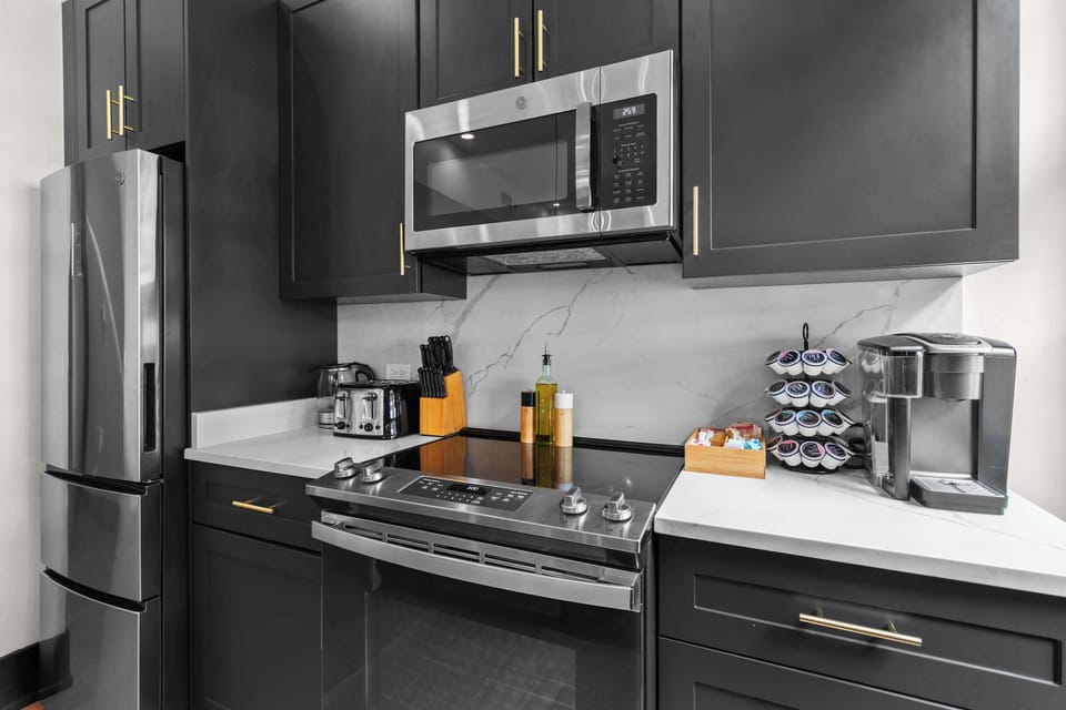 Cook or snack in style with a full kitchen featuring GE stainless appliances, cookware, and an island with bar seating. Ideal for short or extended stays, our kitchens make group travel in New Orleans easy and comfortable.