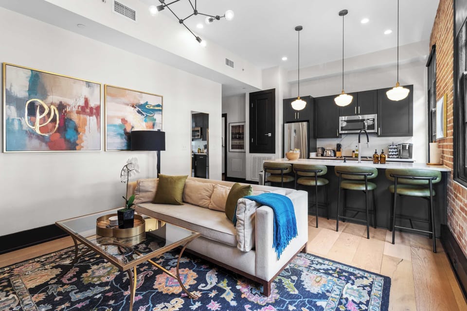 Relax in the living area with a smart TV, stylish seating, and a sleeper sofa for extra guests. Perfect for families or group stays in New Orleans, this inviting space is ideal for movie nights or recharging after a day in the city.