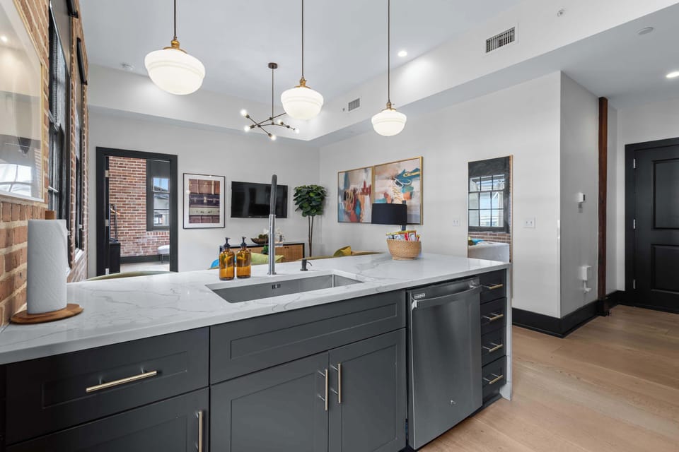 Cook or snack in style with a full kitchen featuring GE stainless appliances, cookware, and an island with bar seating. Ideal for short or extended stays, our kitchens make group travel in New Orleans easy and comfortable.