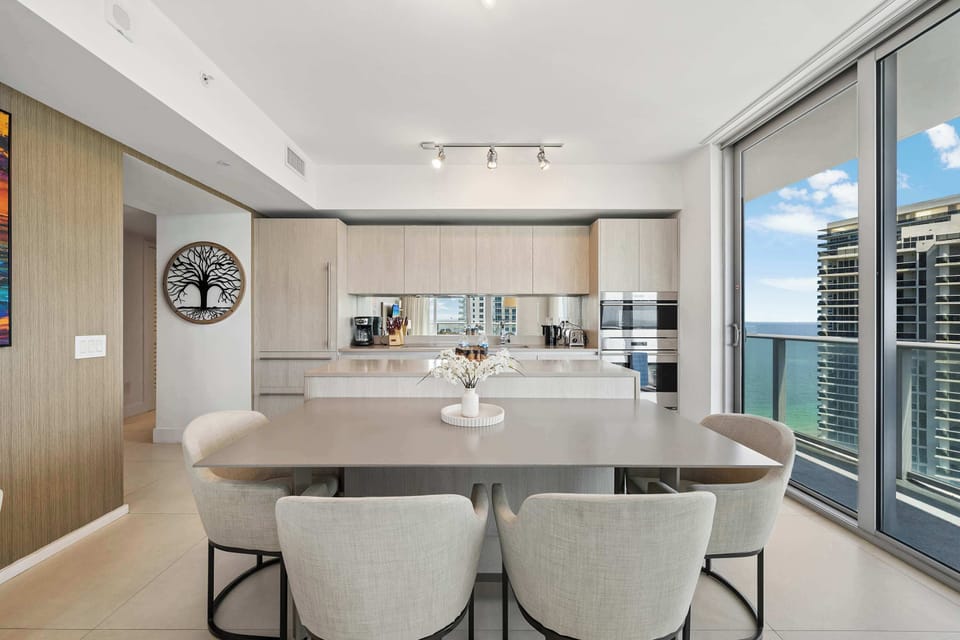 Gather and create family memories around our elegant dining table, framed by panoramic windows