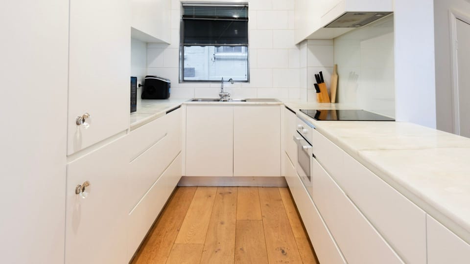 The streamlined kitchen offers plenty of bench space for effortless meal preparation.