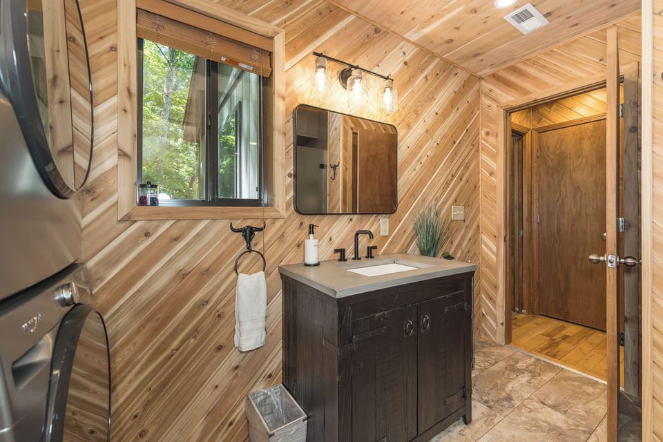 Full bathroom with walk-in shower and in-home laundry.
