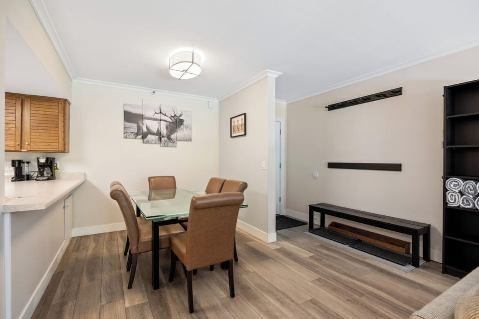 Bright dining area with seating for four, conveniently located next to the kitchen and entryway for easy meals, entertaining, and everyday comfort.