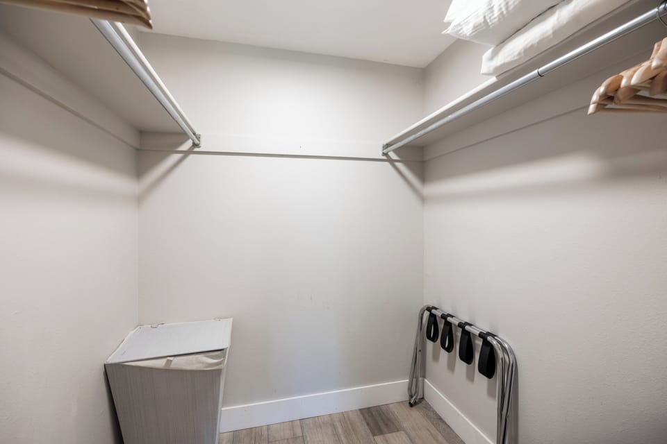 Spacious walk-in closet with hanging space, shelving, and luggage storage to help keep your belongings organized throughout your stay.