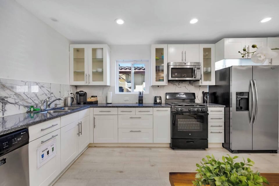 Modern, fully equipped kitchen with stainless steel appliances.