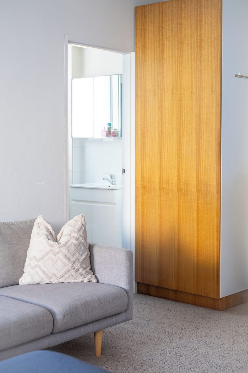 Sofa with view into bathroom through folding door