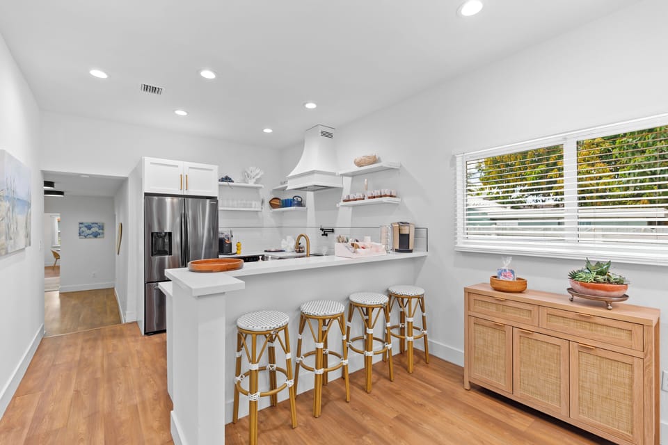 Modern kitchen with oversized island and bar seating for four.
