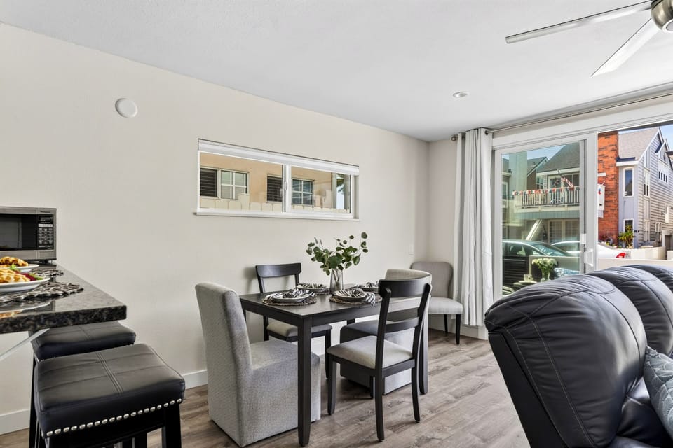Dining area for six set beside sunlit windows and easy patio flow.