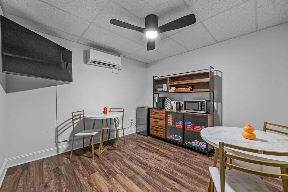 Shared lounge on lower level with two cafe tables.