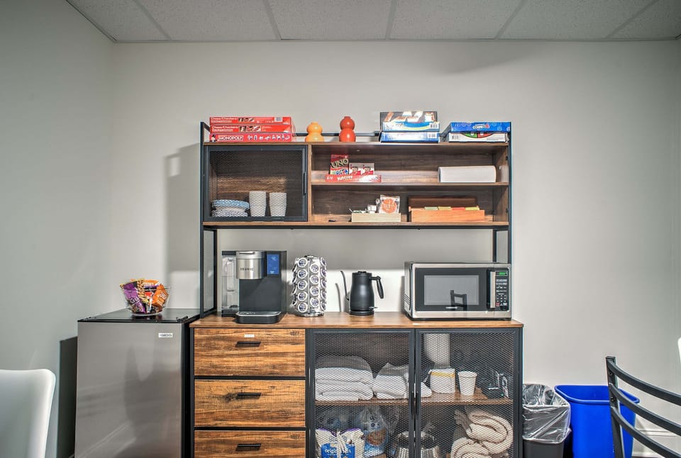Shared community lounge with seating, tables, a Smart TV, board games, and a refreshment station.