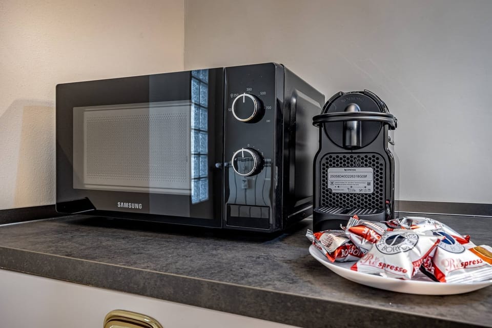 Coffee/tea maker, microwave, dining table