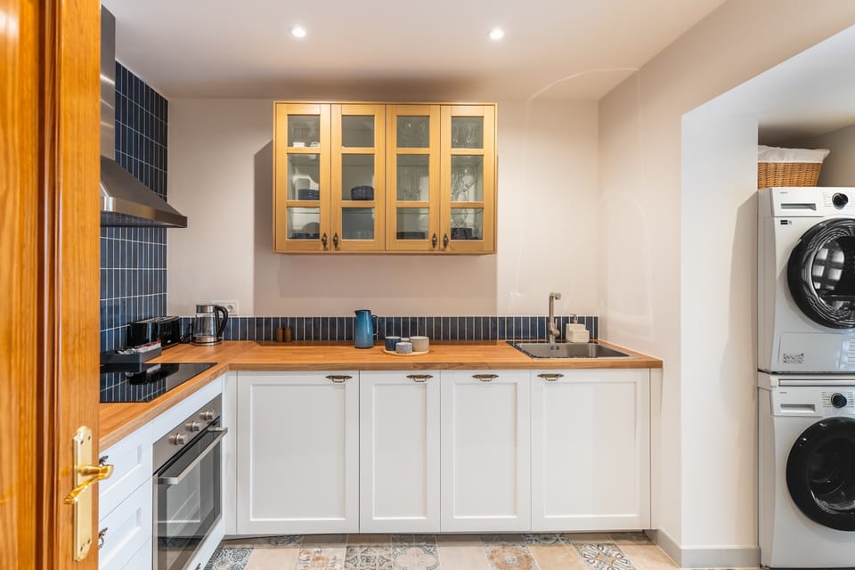 The separate kitchen features an induction hob, oven, dishwasher, fridge, coffee machine, kettle, washing machine and tumble dryer. Cookware, tableware and basic utensils are provided, along with coffee, tea and spices.