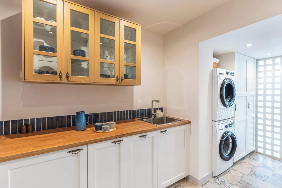 The separate kitchen features an induction hob, oven, dishwasher, fridge, coffee machine, kettle, washing machine and tumble dryer. Cookware, tableware and basic utensils are provided, along with coffee, tea and spices.
