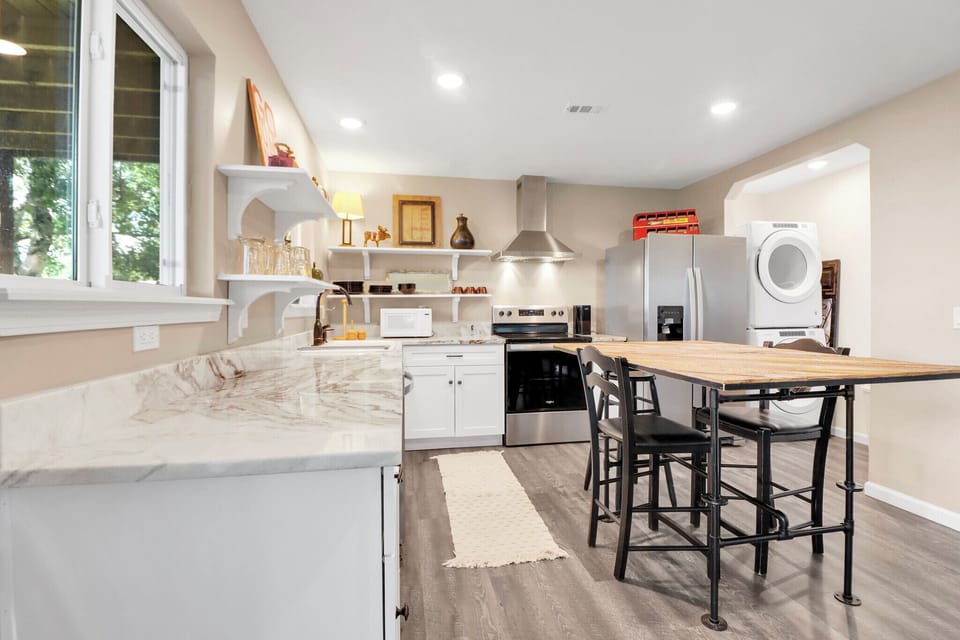 Home cooks will love the light-filled kitchen with natural stone counters, stainless appliances—your home away from home awaits.