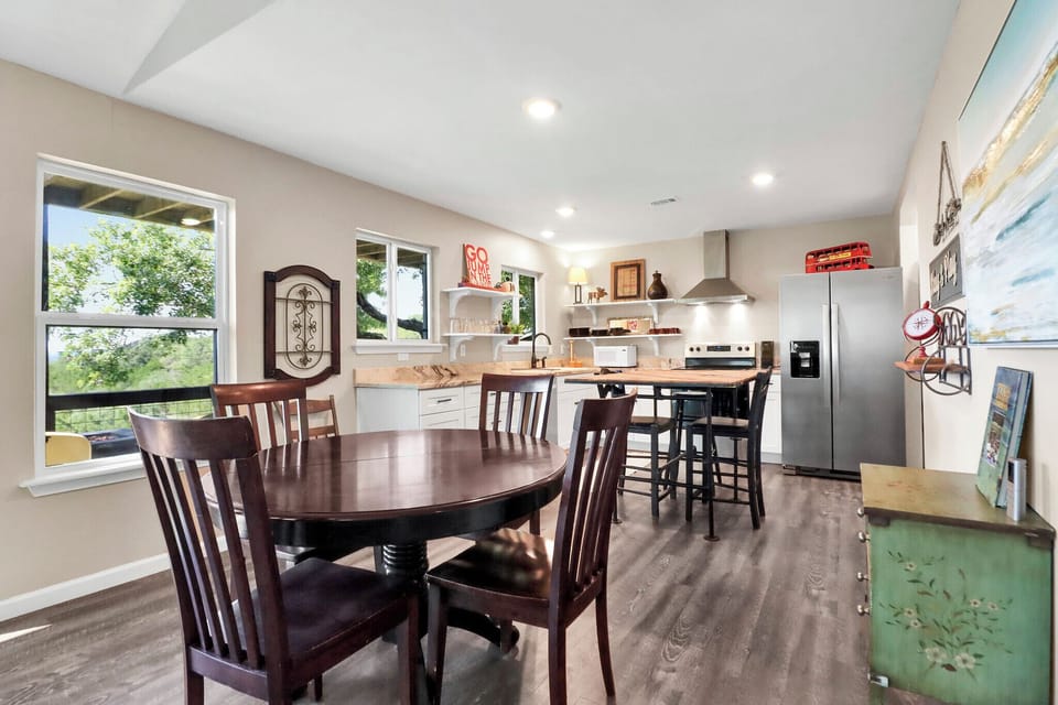 Gather around the dining tables —the open-concept space blends comfort with style, natural light, and scenic views.