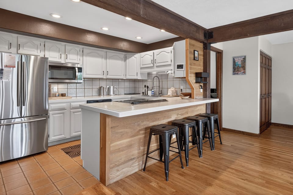Your spacious chef-ready kitchen features gleaming stainless appliances, abundant counter space, and a welcoming breakfast bar perfect for morning coffee or casual meals with loved ones.