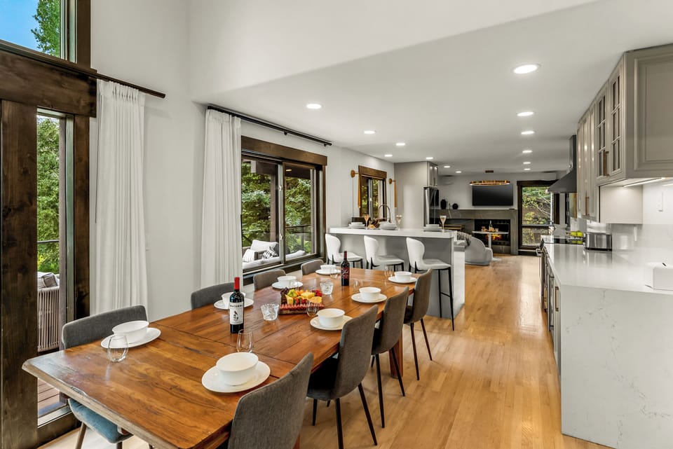 Main floor dining area: 10-seat dining table, 3 barstools
