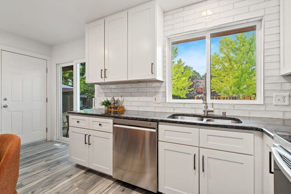 Your bright, modern kitchen offers sleek white cabinetry and stainless steel appliances.