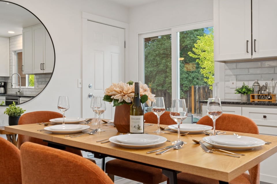 Inviting dining table bathed in natural light from glass doors.