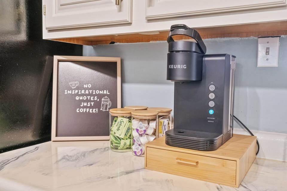 Charming kitchen coffee station with Keurig, pods, tea, and sweeteners