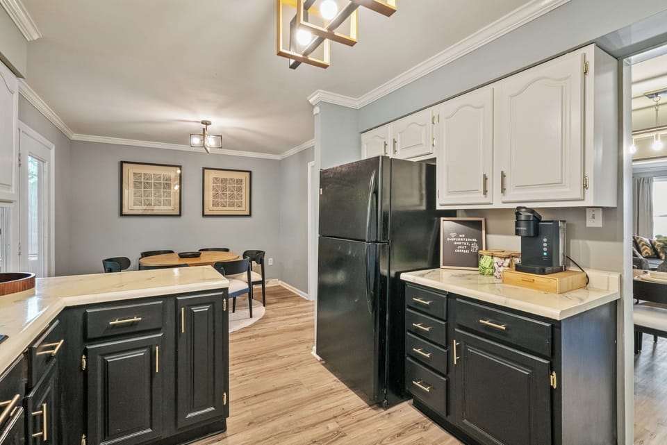 Stylish kitchen with dining nook and modern black-and-white cabinetry