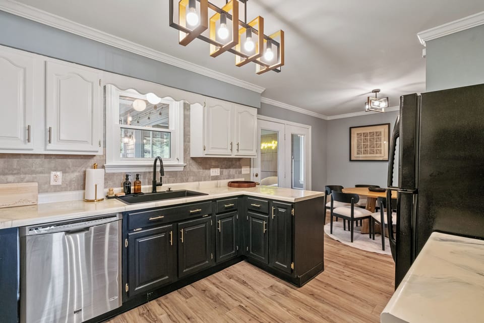 Updated kitchen with dining nook, modern lighting, and stylish finishes