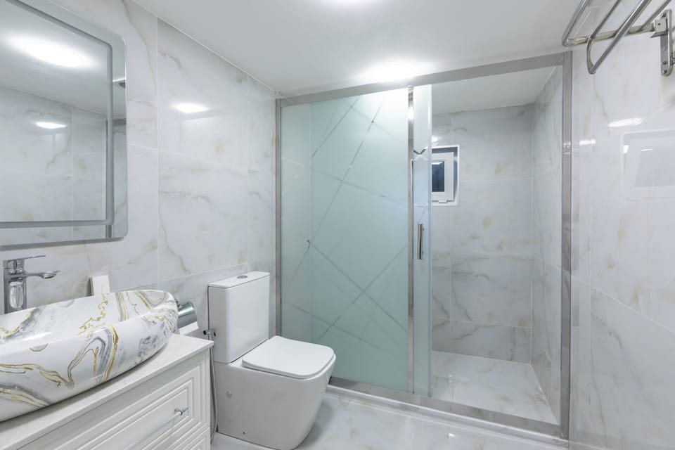Shower, hair dryer, slippers, towels
