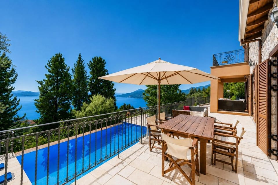 Villa patio with an outdoor dining table and scenic sea views.