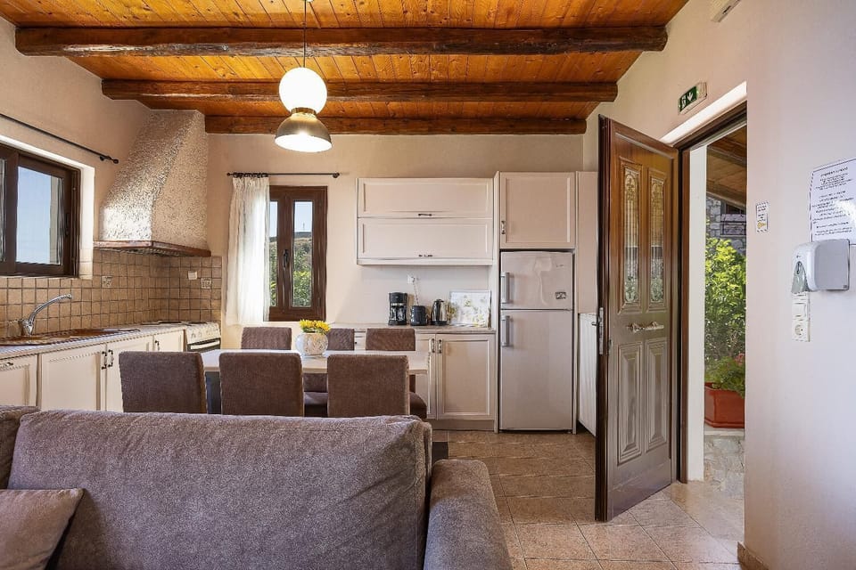 An interior view focusing on the kitchen and entryway of the villa's open-concept living space.
