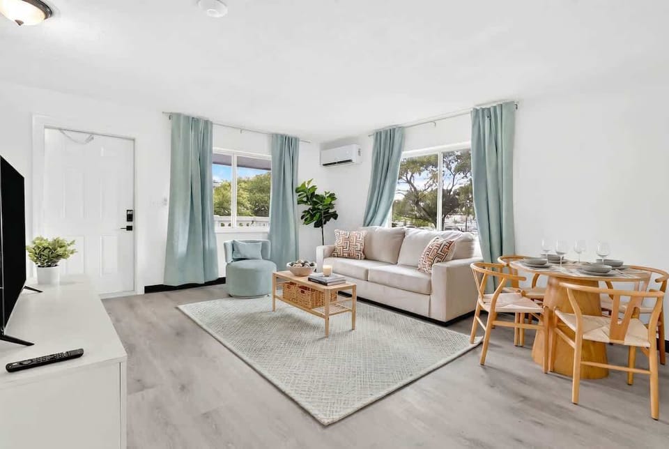 Unwind in the bright living room with comfortable seating and a Smart TV for your entertainment.