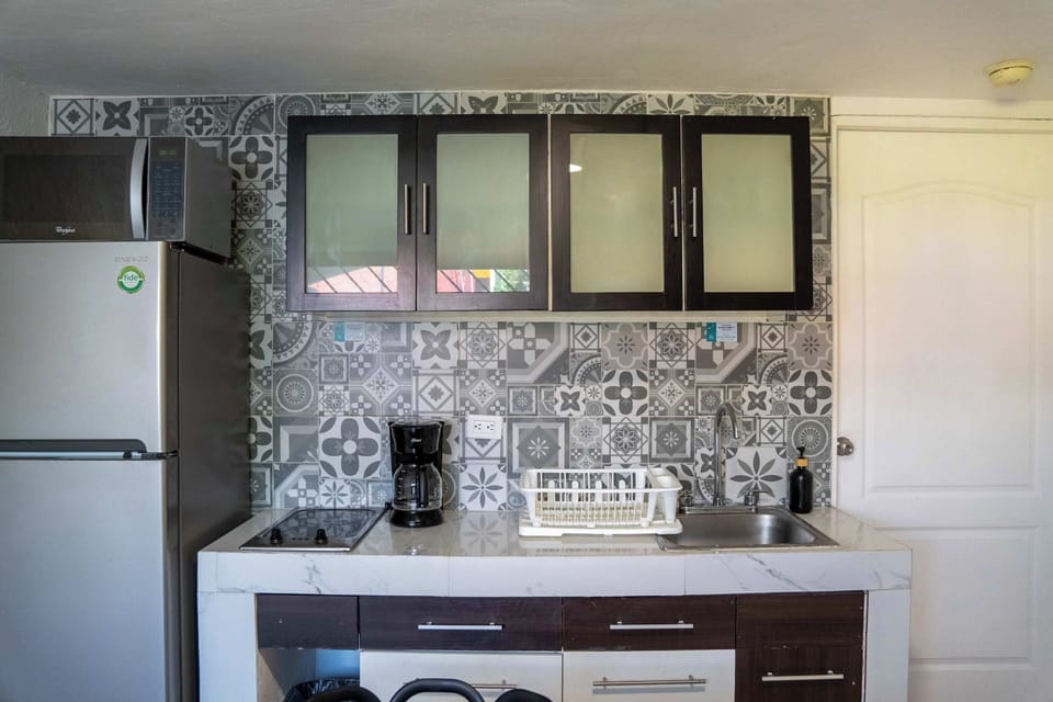 Fully equipped kitchenette with fridge, stovetop and coffee maker for self-catering ease