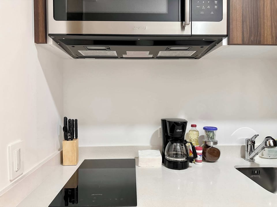 Modern kitchenette with stovetop, coffee maker and the essentials for easy meals